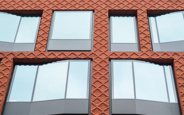 Façade avec des briques rouges et des vitrages